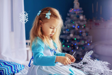 little girl in a dress on New Year's night. The concept of New Year and Christmas