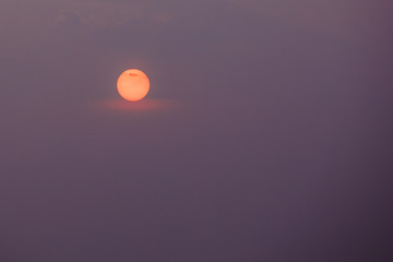 Close View Of Orange Disk Of Setting Rising Sun, Violet Sky Back