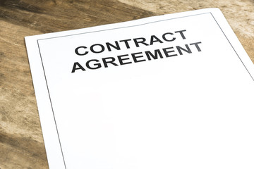 Blank contract agreement paper template on wooden background