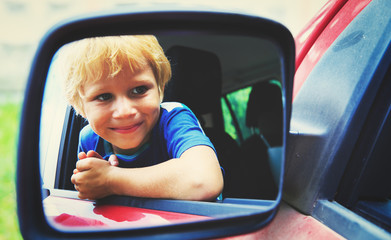 happy little boy travel by car