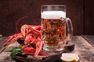 boiled crawfish and beer on a wooden background