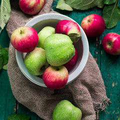 red and green apples on wooden vintage background