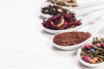 assortment of dry tea on a wooden table,healthy drink