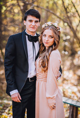 groomsman and bridesmaid in the park embracing.