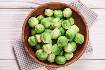 Fresh brussel sprouts over rustic wooden texture.healthy food