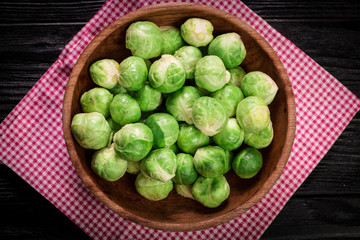 Fresh brussel sprouts over rustic wooden texture.healthy food