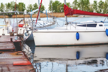 Fototapeta na wymiar White yacht moored to the quay