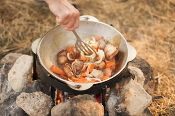 Shurpa -  cooking process on bonfire.
