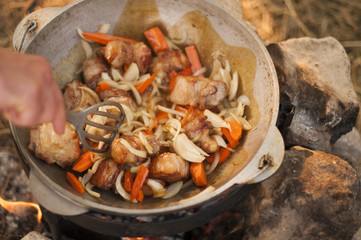 Shurpa -  cooking process on bonfire.