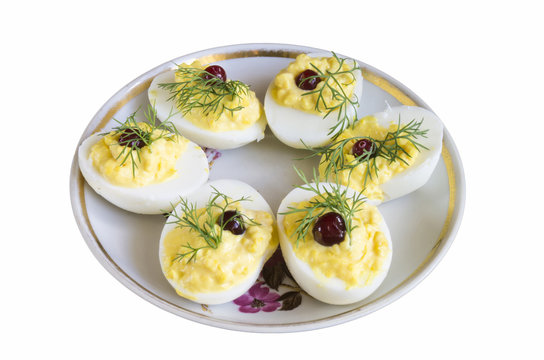 Stuffed egg with cranberry and green dill