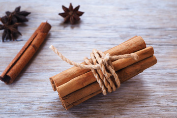 Close up of bundle cinnamon sticks on a wooden background.