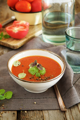 Tomato soup on a wooden table in the kitchen
