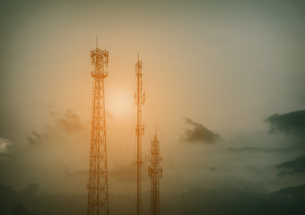 Silhouette telecommunications antenna for mobile phone at sunset