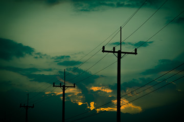 Silhouette electricity post with beautiful sunset background. Vintage tone