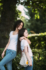 Fototapeta premium mother and daughter posing in the park