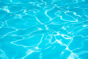 Beautiful water surface in swimming pool with sun reflection
