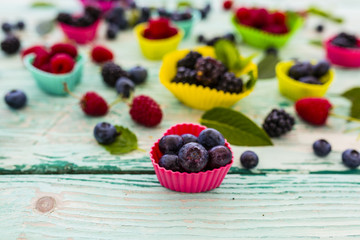 Tasty forest fruits on wooden table.