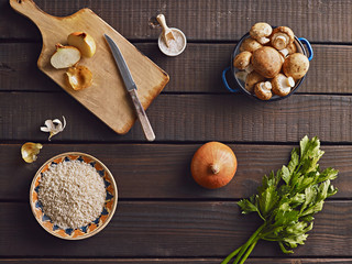 Obraz na płótnie Canvas Risotto ingredients - rice, mushrooms, onion, parsley, salt. Top view.