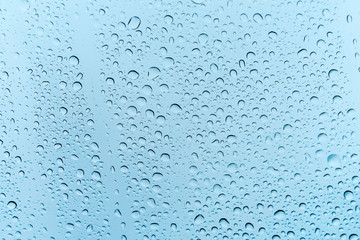 Rain dew drop on dirty glass with dirt dust and scratches, selective focus with vintage color tone effect,Water Abstract background.