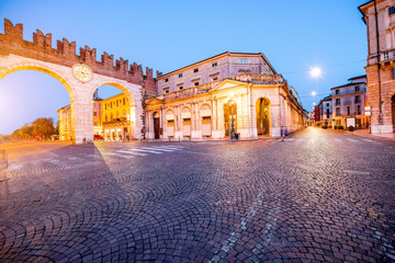 Naklejka na ściany i meble Night view on illuminated Portoni della Bra gate with museum in Verona city.