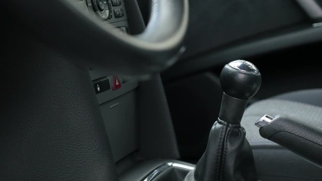 Car interior with gear shift stick and hand brake details 4K 2160p 30fps UltraHD tilting footage - Slow tilt inside car with details of steering wheel 4K 3840X2160 UHD video 