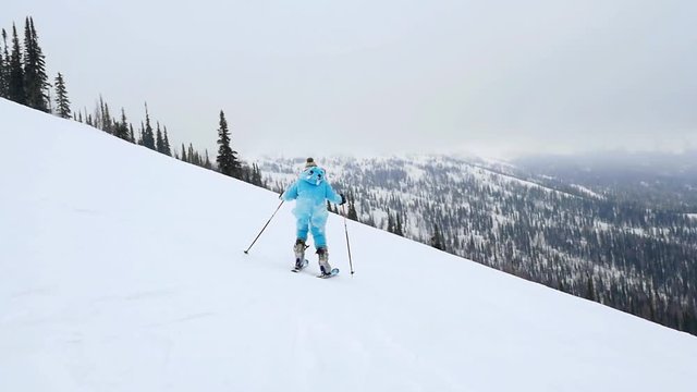 Son and father skiers on the slope at a ski resort in the Alps in slowmotion. 1920x1080