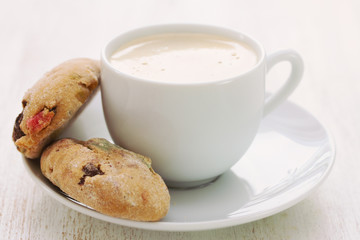 cup of coffee with cookies on wooden background