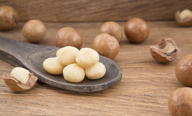 Macadamia nuts on wooden background