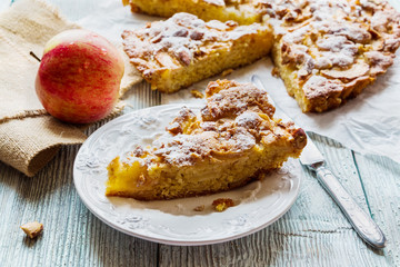 Piece of homemade sweet fruit cake. Made with apples, almond, vanilla and icing sugar