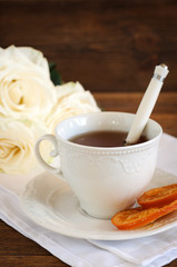 Tea in elegant porcelain cup, candied oranges