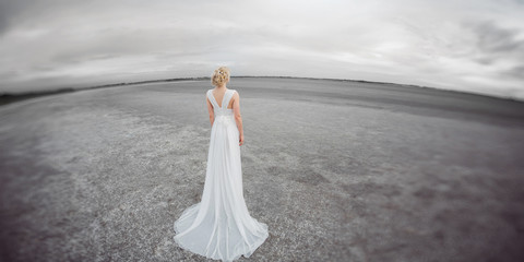 Fototapeta na wymiar Beautiful bride outdoors in a desert.