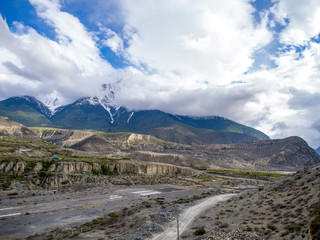 Airport runway in the mountain valley with the overcast weather snow mountain as background, Jomsom, Annapurna Conservation Area, Nepal