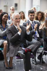 Audience Applauding Speaker After Conference Presentation