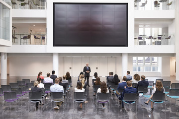 Mature Businessman Making Presentation At Conference