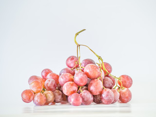 Ripe red grapes bunch on gray background