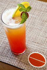 Refreshing cold glass of colorful Sex on the Beach cocktail with