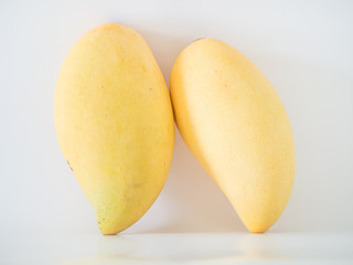 Fresh delicious yellow mangoes on gray background