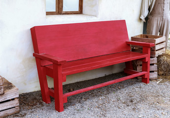 Red wooden bench on the farm.