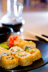 Japanese rolls with fish on a black background
