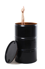 thumbs up from the barrel isolated on white background. male hand showing thumbs up sticking out of the black metal barrel. business concept.