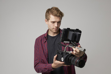 Obraz premium Studio Portrait Of Male Videographer With Film Camera