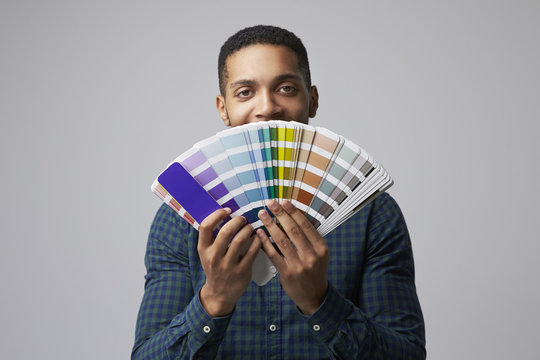 Studio Portrait Of Graphic Designer With Color Swatches - Powered by Adobe