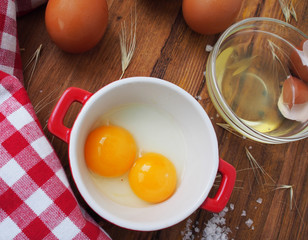 Raw eggs in red and white bowl