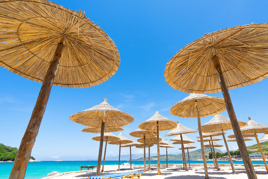 Sunshade beach umbrellas with sky and sea background.  Selective focus.