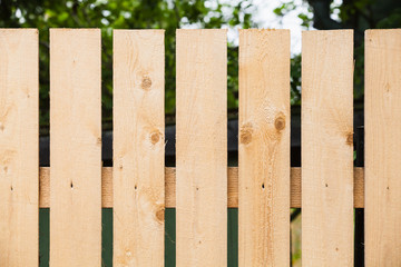 Fototapeta premium Fragment of new wooden fence in garden