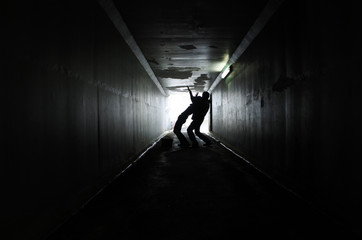 Man attacks a woman in a dark tunnel