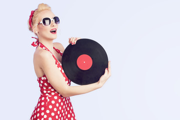Girl pin-up retro holding a vinyl record