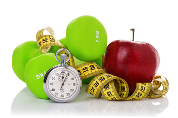 Two dumbbells, red apple, measuring tape.