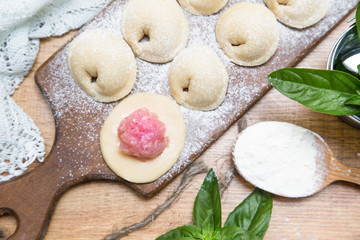 Making meat dumplings. Traditional russian food.