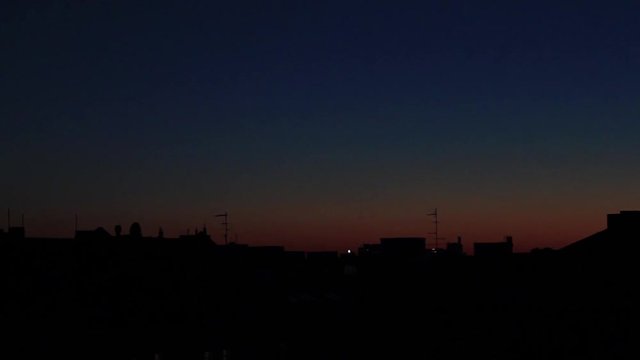 sunset sky over city skyline time lapse